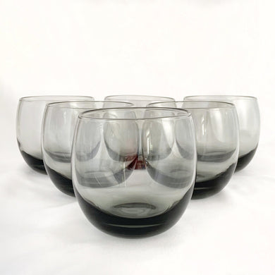 Set of six vintage mid-century smokey gray roly poly cocktail glasses. These gorgeous, heavily weighted glasses make a fabulous addition to any barware collection. Crafted by Libbey Glass, USA, 1960s. Bring on the Mad Men vibes!

In excellent condition, no chips or cracks.

Measures 3 1/4 x 3 1/8 inches