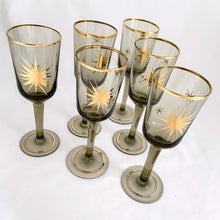 Load image into Gallery viewer, Gorgeous set of six vintage mid-century modern smokey brown liquor glasses decorated with atomic gold stars and rims.  In excellent condition, free from chips/wear.  Measures 1 3/4 x 5 1/8 inchesGorgeous set of six vintage mid-century modern smokey brown liquor glasses decorated with atomic gold stars and rims.  In excellent condition, free from chips/wear.  Measures 1 3/4 x 5 1/8 inches
