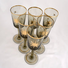 Load image into Gallery viewer, Gorgeous set of six vintage mid-century modern smokey brown liquor glasses decorated with atomic gold stars and rims.  In excellent condition, free from chips/wear.  Measures 1 3/4 x 5 1/8 inchesGorgeous set of six vintage mid-century modern smokey brown liquor glasses decorated with atomic gold stars and rims.  In excellent condition, free from chips/wear.  Measures 1 3/4 x 5 1/8 inches
