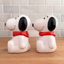 Load image into Gallery viewer, Vintage retro Snoopy character ceramic salt and pepper shakers with plastic stoppers. B&amp;M Inc., Taiwan, 1970s. Add these adorable and highly collectible shakers to your collection!

In excellent vintage condition, no chips/cracks/repairs. Maker&#39;s mark and sticker.

Measures 2 1/4 x 2 3/4 x 3 3/4 inches
