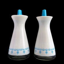 Load image into Gallery viewer, This is a pair of vintage PYREX oil and vinegar white cruets featuring the &quot;Snowflake Garland&quot; pattern in white on turquoise with matching lids. Crafted by Corning Glass, USA, 1972 - 1975.&nbsp;These look brand spanking new and will make&nbsp;a great addition to your tablescape or PYREX collection!  Both the glass and plastic tops are in excellent condition, no chips/wear.  Measures 2 x 4 1/2 inches
