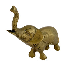Load image into Gallery viewer, Elevated angled view of vintage solid brass lucky elephant figurine with trunk raised, 1970s Korea, warm patina
