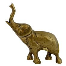 Load image into Gallery viewer, Left-side profile of vintage solid brass lucky elephant figurine with trunk raised, original Korea sticker visible, 1970s
