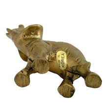 Load image into Gallery viewer, Underside view of vintage solid brass elephant figurine showing original "Made in Korea" sticker, 1970s, aged brass

