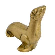 Load image into Gallery viewer, Three-quarter front view of vintage solid brass seal figurine in upright seated pose, face and body detail visible, aged golden patina, 1970s Taiwan 
