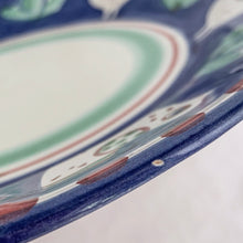 Load image into Gallery viewer, Gorgeous vintage Solimene chicken serving plate produced by Vietri for Target, circa 2007. Made in Italy. This playful pottery is decorated with white chickens against cobalt blue, greenery, red dots along the edge and bands of red and green in the centre all on a white ground.  In good vintage condition. Minor chip to the rim and a manufacturer&#39;s defect on the back. Please see photos.  Measures 13 1/2 x 1 3/4 inches
