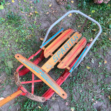 Load image into Gallery viewer, Classic vintage mid-century Spartan child&#39;s pull snow sleigh or sled. This one features a steel frame with red metal skis, wood slat deck and steering bar, metal backrest and long wood handle with red metal hand grip. Crafted by Werlich Industries, Canada, 1960s. Bring back all the wonderful of snowy winter days with this beloved wee sled!

In as found vintage condition with wear to the entire piece commensurate with use and age. Original sticker present.
