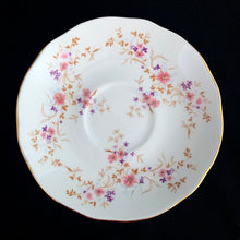 Load image into Gallery viewer, Vintage Spinney white bone china teacup and saucer features pink, purple and gold florals, trimmed in gold gilt. Crafted by Duchess, England, 1960s. A lovely way to enjoy a cuppa tea!

In excellent condition, no chips, cracks or repairs. Maker&#39;s mark on the bottom.

Measures 3 7/8 x 2 3/4 x 5 1/2 inches
