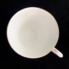Load image into Gallery viewer, Vintage Spinney white bone china teacup and saucer features pink, purple and gold florals, trimmed in gold gilt. Crafted by Duchess, England, 1960s. A lovely way to enjoy a cuppa tea!

In excellent condition, no chips, cracks or repairs. Maker&#39;s mark on the bottom.

Measures 3 7/8 x 2 3/4 x 5 1/2 inches
