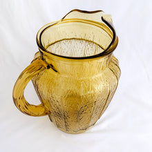 Load image into Gallery viewer, This vintage &quot;Sprucewood Honey Gold&quot; ice lip pressed glass pitcher features a paneled shape with a bark-like design. Crafted by Anchor Hocking, USA, circa 1970s. A great addition to your tablescape or barware!  In excellent condition, free from chips.  Measures 5 1/2 x 8 inches  Capacity 86 ounces
