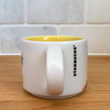 Load image into Gallery viewer, This sweet Starbucks collectible &quot;FLORIDA&quot; mini ceramic mug Christmas ornament from the &quot;You Are Here&quot; Collection, 2016. This white mug features a graphic skyline design in shades of yellow, orange and blue with yellow interior. Celebrate the sunshine state with an espresso!

In excellent condition, free from chips/cracks/wear.

Measures 2 3/8 x 1 7/8 inches

Capacity 2 ounces
