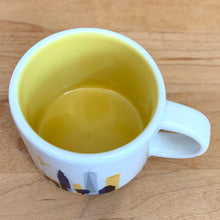 Load image into Gallery viewer, This sweet Starbucks collectible NEW YORK mini ceramic mug Christmas ornament from the You Are Here Collection, 2016. This white mug features a graphic skyline design in shades of yellow, orange and blue with yellow interior. Celebrate the Empire State with an espresso!

In excellent condition, free from chips/cracks/wear.

Measures 2 3/8 x 1 7/8 inches

Capacity 2 ounces
