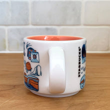 Load image into Gallery viewer, This sweet Starbucks collectible TENNESSEE mini ceramic mug Christmas ornament from the Been There Series Across the Globe Collection, 2016. This white mug depicting all things Tennessee in shades of yellow, orange and blue with yellow interior. Celebrate the The Big Bend State with an espresso!

In excellent condition, free from chips/cracks/wear.

Measures 2 3/8 x 1 7/8 inches

Capacity 2 ounces
