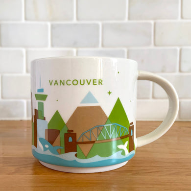 Perfect for your morning cuppa joe to make you feel like a world traveller! This fabulous collectible VANCOUVER ceramic mug was produced by Starbucks as part of their YOU ARE HERE collection, 2014. A white ceramic mug printed design in shades of green blue, brown and red with blue interior. Celebrate the By Sea, Land, and Air We Prosper city!

In excellent condition, free from chips/cracks/wear.

Measures 3 5/8 x 3 3/8 inches

Capacity 14 ounces