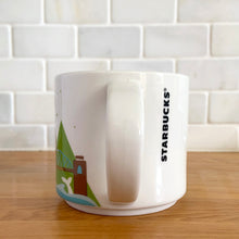 Load image into Gallery viewer, Perfect for your morning cuppa joe to make you feel like a world traveller! This fabulous collectible VANCOUVER ceramic mug was produced by Starbucks as part of their YOU ARE HERE collection, 2014. A white ceramic mug printed design in shades of green blue, brown and red with blue interior. Celebrate the By Sea, Land, and Air We Prosper city!

In excellent condition, free from chips/cracks/wear.

Measures 3 5/8 x 3 3/8 inches

Capacity 14 ounces
