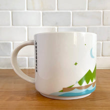 Load image into Gallery viewer, Perfect for your morning cuppa joe to make you feel like a world traveller! This fabulous collectible VANCOUVER ceramic mug was produced by Starbucks as part of their YOU ARE HERE collection, 2014. A white ceramic mug printed design in shades of green blue, brown and red with blue interior. Celebrate the By Sea, Land, and Air We Prosper city!

In excellent condition, free from chips/cracks/wear.

Measures 3 5/8 x 3 3/8 inches

Capacity 14 ounces
