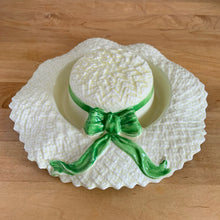 Load image into Gallery viewer, Delightful vintage pale yellow straw hat with green bow ceramic posy vase. Crafted by Falcon Ware, England, 1940s. Fill will flowers to create a charming floral centrepiece.

In excellent condition, no chips/cracks/repairs.

Measures 8 1/2 x 2 1/4 inches
