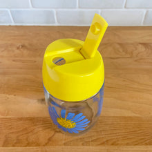 Load image into Gallery viewer, Classic vintage clear glass sugar dispenser, decorated with a series of blue flowers with yellows centres, topped with a bright yellow flip top plastic lid. Crafted by Dominion Glass Canada, circa 1980s.  Glass is in excellent condition, free from chips/cracks.  Measures 2 3/4 x 5 1/2 inches
