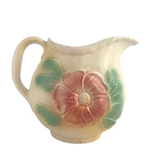 Load image into Gallery viewer, Vintage mid-century Sun Glow pale yellow ceramic pitcher with embossed pink dogwood flowers on a on pale yellow ground. Crafted by Hull, USA, circa 1950s. A great way to add charm to your tableware.

In as found vintage condition, chip to the foot, no cracks/repairs. Marked.

Measures 7 x 3 3/4 x 5 3/8 inches

Capacity 24 ounces
