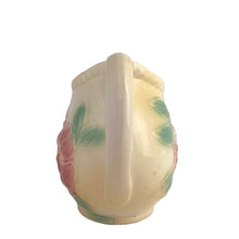 Load image into Gallery viewer, Vintage mid-century Sun Glow pale yellow ceramic pitcher with embossed pink dogwood flowers on a on pale yellow ground. Crafted by Hull, USA, circa 1950s. A great way to add charm to your tableware.

In as found vintage condition, chip to the foot, no cracks/repairs. Marked.

Measures 7 x 3 3/4 x 5 3/8 inches

Capacity 24 ounces

