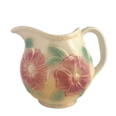 Vintage mid-century Sun Glow pale yellow ceramic pitcher with embossed pink dogwood flowers on a on pale yellow ground. Crafted by Hull, USA, circa 1950s. A great way to add charm to your tableware.

In as found vintage condition, chip to the foot, no cracks/repairs. Marked.

Measures 7 x 3 3/4 x 5 3/8 inches

Capacity 24 ounces