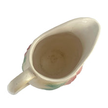 Load image into Gallery viewer, Vintage mid-century Sun Glow pale yellow ceramic pitcher with embossed pink dogwood flowers on a on pale yellow ground. Crafted by Hull, USA, circa 1950s. A great way to add charm to your tableware.

In as found vintage condition, chip to the foot, no cracks/repairs. Marked.

Measures 7 x 3 3/4 x 5 3/8 inches

Capacity 24 ounces
