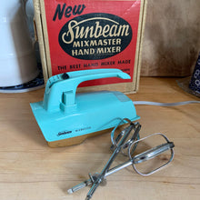 Load image into Gallery viewer, Fabulous vintage turquoise and gold Sunbeam Mixmaster hand mixer. Crafted by the Sunbeam Corporation, Canada, 1957. The mixer is in the original box with 2 beaters and instruction/recipe booklet and has the original packing slip on the outside of the box in an envelope. A must-have for any baker or appliance collector! Tested. In good working order.
