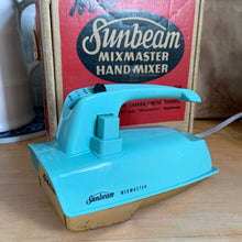 Load image into Gallery viewer, Fabulous vintage turquoise and gold Sunbeam Mixmaster hand mixer. Crafted by the Sunbeam Corporation, Canada, 1957. The mixer is in the original box with 2 beaters and instruction/recipe booklet and has the original packing slip on the outside of the box in an envelope. A must-have for any baker or appliance collector! Tested. In good working order.
