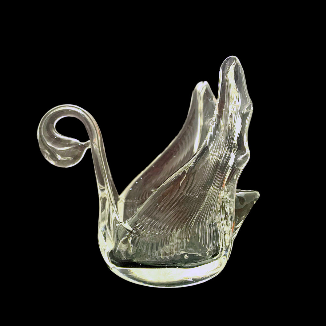 Experience the timeless beauty of this vintage hand blown clear art glass swan bomboniere. Crafted by Chalet Glass, Canada, circa 1970s.  Transform any space with its versatile use as a decoration or as a votive or tealight holder for a warm and inviting atmosphere.  In excellent condition, free from chips.  Measures 4 1/2 x 2 3/4 x 4 inches   