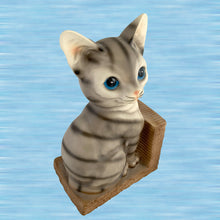 Load image into Gallery viewer, Three-quarter view of vintage kitschy tabby cat ceramic bookend showing blue eyes and basketweave base detail
