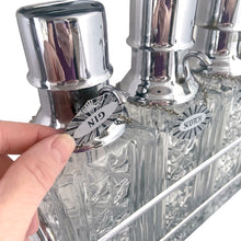 Load image into Gallery viewer, Keep your liquid gold safe with this vintage mid-century era tantalus lockable bar featuring three pressed glass decanters with chrome pumps, reversible liquor tags and sturdy chrome caddy. A fantastic addition to your barware collection!

Overall measures 11 1/2 x 4 x 13 1/4

Each decanter hold 1 quart or 1 litre

Note, lock not included.
