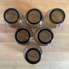 Load image into Gallery viewer, Overhead view of 6 vintage Dominion Glass Tulip tumbler bottoms
