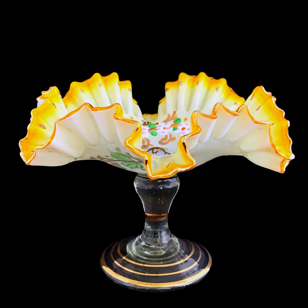 Antique opalescent glass compote featuring graduating of colour from pale to deep yellow, featuring hand painted enamel florals in white, mauve, green and gold with a double crimped gold gilt edge. The applied pedestal is clear green tinged blown glass with gold gilt. Crafted by Tazza Glass, Czechoslovakia, 1920s. A gorgeous piece of early art glass!  In excellent condition, free from chips/wear.  Measures 7 1/2 x 5 inches