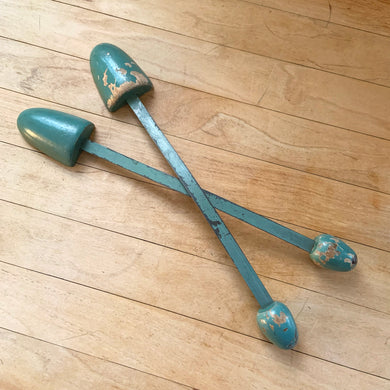 Vintage pair of ladies wood and metal shoe stretchers in teal blue. These feature wood ends between a flexible metal strap. Perfect to help your shoes retain their original shape. Circa 1950s. Could be used for decor or as a prop.  In good vintage condition with minor age-related wear.  Measures approximately 11 1/2 inches long