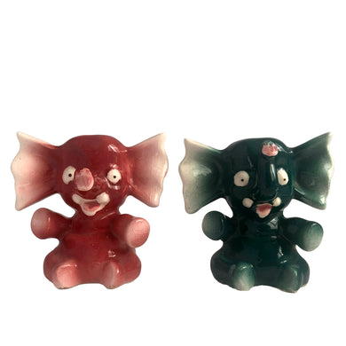 Adorable hand painted anthropomorphic teal and burgundy elephant salt and pepper shakers. Crafted in Japan, 1950s. A sweet kitschy shaker set for your new addition. Use for tiny plants or repurpose to hold baby accessories.

In excellent vintage condition, no chips, with corks.

Measures 3 x 2 1/8 x 3 1/8 inches