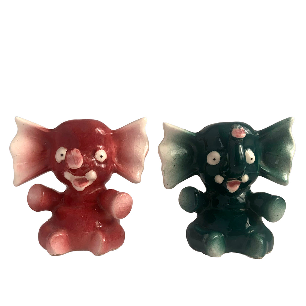Adorable hand painted anthropomorphic teal and burgundy elephant salt and pepper shakers. Crafted in Japan, 1950s. A sweet kitschy shaker set for your new addition. Use for tiny plants or repurpose to hold baby accessories.

In excellent vintage condition, no chips, with corks.

Measures 3 x 2 1/8 x 3 1/8 inches