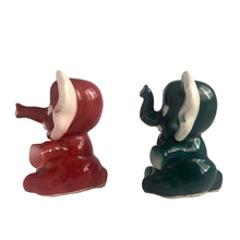 Load image into Gallery viewer, Adorable hand painted anthropomorphic teal and burgundy elephant salt and pepper shakers. Crafted in Japan, 1950s. A sweet kitschy shaker set for your new addition. Use for tiny plants or repurpose to hold baby accessories.

In excellent vintage condition, no chips, with corks.

Measures 3 x 2 1/8 x 3 1/8 inches
