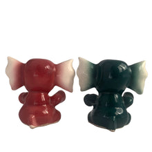 Load image into Gallery viewer, Adorable hand painted anthropomorphic teal and burgundy elephant salt and pepper shakers. Crafted in Japan, 1950s. A sweet kitschy shaker set for your new addition. Use for tiny plants or repurpose to hold baby accessories.

In excellent vintage condition, no chips, with corks.

Measures 3 x 2 1/8 x 3 1/8 inches
