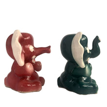Load image into Gallery viewer, Adorable hand painted anthropomorphic teal and burgundy elephant salt and pepper shakers. Crafted in Japan, 1950s. A sweet kitschy shaker set for your new addition. Use for tiny plants or repurpose to hold baby accessories.

In excellent vintage condition, no chips, with corks.

Measures 3 x 2 1/8 x 3 1/8 inches

