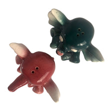 Load image into Gallery viewer, Adorable hand painted anthropomorphic teal and burgundy elephant salt and pepper shakers. Crafted in Japan, 1950s. A sweet kitschy shaker set for your new addition. Use for tiny plants or repurpose to hold baby accessories.

In excellent vintage condition, no chips, with corks.

Measures 3 x 2 1/8 x 3 1/8 inches
