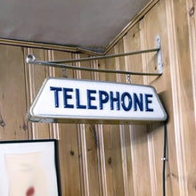 Load image into Gallery viewer, Fabulous find!!! Vintage electric lighted telephone sign with metal wall bracket for ease of hanging. The cobalt blue raised lettering is molded white plastic. Crafted by Brouillette Signs Ltc. Montreal Canada, circa 1940s. This sign was sourced from the estate of the Dale family pharmacy in downtown Toronto Canada. A great piece of Canadian advertising craftsmanship.
