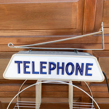 Load image into Gallery viewer, Fabulous find!!! Vintage electric lighted telephone sign with metal wall bracket for ease of hanging. The cobalt blue raised lettering is molded white plastic. Crafted by Brouillette Signs Ltc. Montreal Canada, circa 1940s. This sign was sourced from the estate of the Dale family pharmacy in downtown Toronto Canada. A great piece of Canadian advertising craftsmanship.
