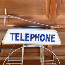 Load image into Gallery viewer, Fabulous find!!! Vintage electric lighted telephone sign with metal wall bracket for ease of hanging. The cobalt blue raised lettering is molded white plastic. Crafted by Brouillette Signs Ltc. Montreal Canada, circa 1940s. This sign was sourced from the estate of the Dale family pharmacy in downtown Toronto Canada. A great piece of Canadian advertising craftsmanship.
