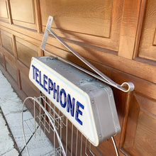 Load image into Gallery viewer, Fabulous find!!! Vintage electric lighted telephone sign with metal wall bracket for ease of hanging. The cobalt blue raised lettering is molded white plastic. Crafted by Brouillette Signs Ltc. Montreal Canada, circa 1940s. This sign was sourced from the estate of the Dale family pharmacy in downtown Toronto Canada. A great piece of Canadian advertising craftsmanship.
