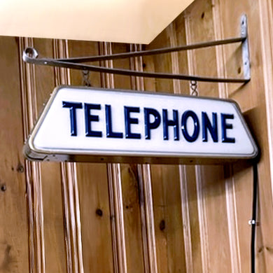 Rare vintage mid-century era double sided hanging electric telephone sign features cobalt blue raised lettering on molded white acrylic and scrolled metal wall bracket. By Brouillette Signs Ltc. Montreal Canada, 1950s. Sourced from the family of the Dale Pharmacy previously located on Queen Street East in Toronto Canada. A piece of Canadian advertising history, craftsmanship and nostalgia that would make a unique addition to any advertising collection and industrial, commercial or home decor.