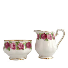 Load image into Gallery viewer, Vintage The Old Country Countess shaped creamer and sugar features a lovely pattern of roses in shades of pink and green with gold gilt details at the rims and handle. Crafted by Royal Albert, England between 1950s - 1960s. A lovely addition to your tableware collection!  In excellent condition, no chips/cracks/repairs. Maker&#39;s marks present.  Creamer measures 2 1/2 x 3 1/4 inches  Sugar measures 3 1/4 x 2 inches
