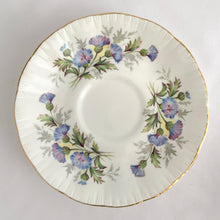 Load image into Gallery viewer, Stunning vintage white porcelain teacup and matching saucer decorated featuring thistle flowers in shades of purple and green plus gold gilt details with a spray of flowers on the interior of the teacup. Part of the English Flowers series produced by The Paragon China Company, England, circa 1950.  In excellent condition, free from chips/cracks/repairs. Marked on the bottom with single warrant stamp.  Teacup measures 3 1/8 x 2 3/4 inches  Saucer measures 5 3/8 inches
