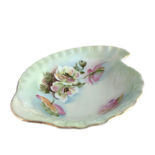 Load image into Gallery viewer, An exquisite vintage hand painted porcelain dish featuring the delicate To A Wild Rose pattern (model 2602). Crafted by Lefton, Japan 1950s. This kidney-shaped dish showcases intricate botanical motif in soft, naturalistic hues and gold rim, making each piece genuinely one-of-a-kind. Ideal for collectors of vintage tableware, decorative display, or as a refined accent piece, this dish exemplifies the quality and aesthetic refinement that defined Lefton's legacy. Perfect for holding trinkets, nuts or mints.
