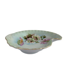 Load image into Gallery viewer, An exquisite vintage hand painted porcelain dish featuring the delicate To A Wild Rose pattern (model 2602). Crafted by Lefton, Japan 1950s. This kidney-shaped dish showcases intricate botanical motif in soft, naturalistic hues and gold rim, making each piece genuinely one-of-a-kind. Ideal for collectors of vintage tableware, decorative display, or as a refined accent piece, this dish exemplifies the quality and aesthetic refinement that defined Lefton's legacy. Perfect for holding trinkets, nuts or mints.
