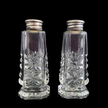 Load image into Gallery viewer, Enhance your tablescape with these sparkling vintage fine cut crystal tower-shaped footed salt and peppers shakers topped with silver lids inlaid with mother-of-pearl....stunning! The crystal is in excellent condition, free from chips. The sterling silver lids show wear. Measures 1 3/8 x 3 1/4 inches

